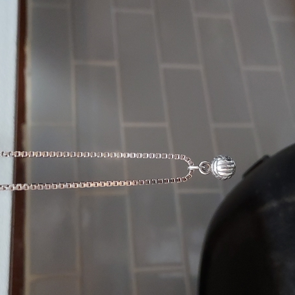 Tiny volleyball necklace. Silver color.